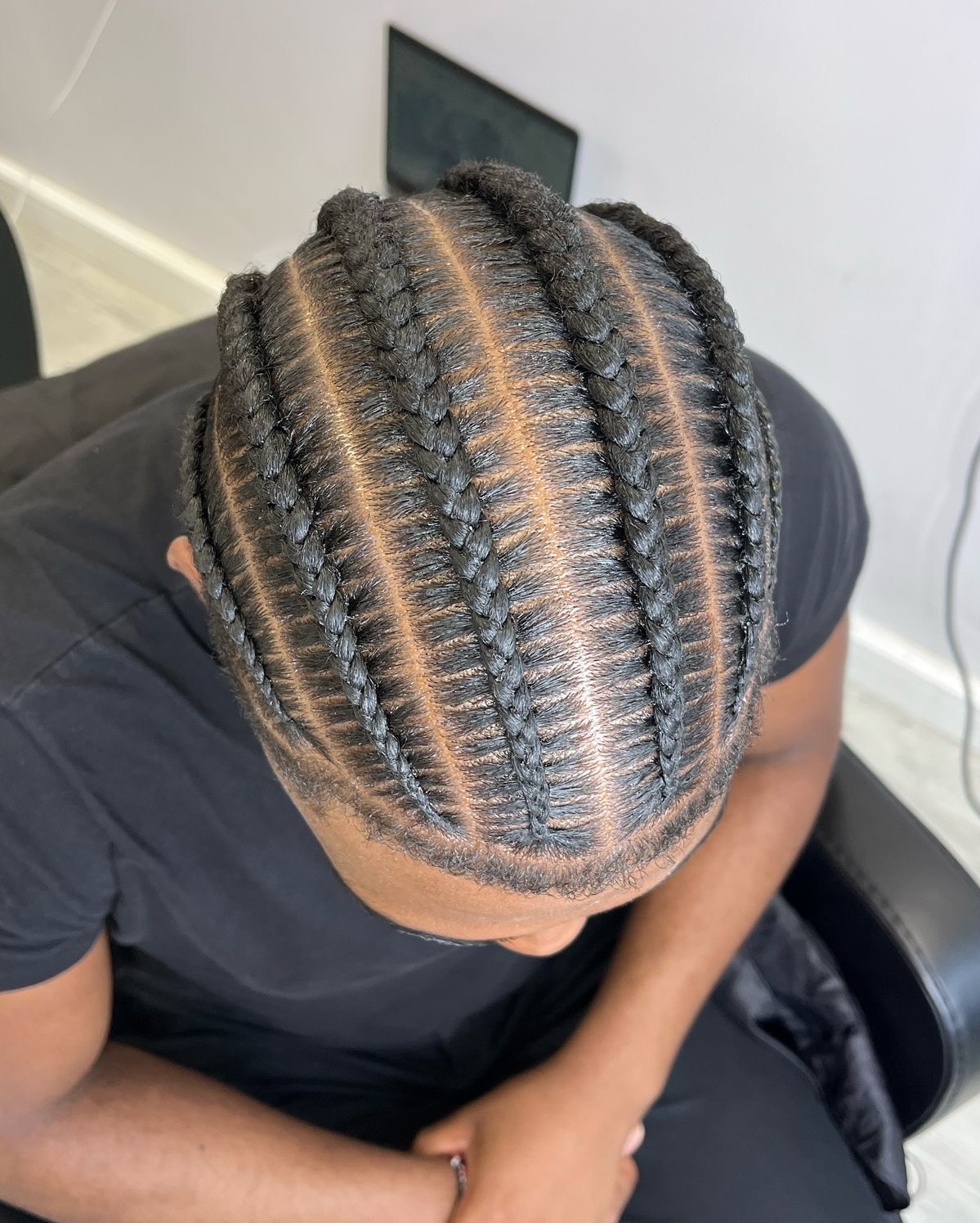 Curved cornrow pattern braided close to the scalp